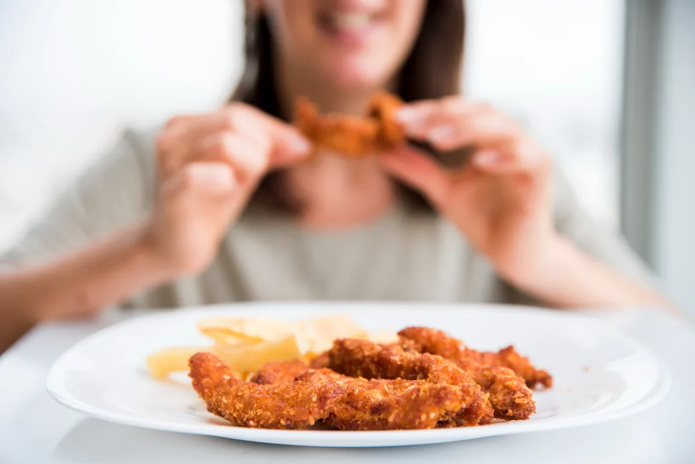 girl-eating-fried-chicken-leg