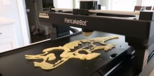 pancake bot food printer printing a dinosaur